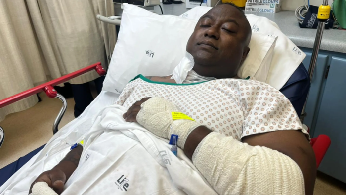 Security officer, Steffen Govender, is in ICU after being shot three times while pursuing armed robbers in a deadly cash-in-transit heist. One woman died, and several others were injured. Police are searching for the suspects. Credit: IOL