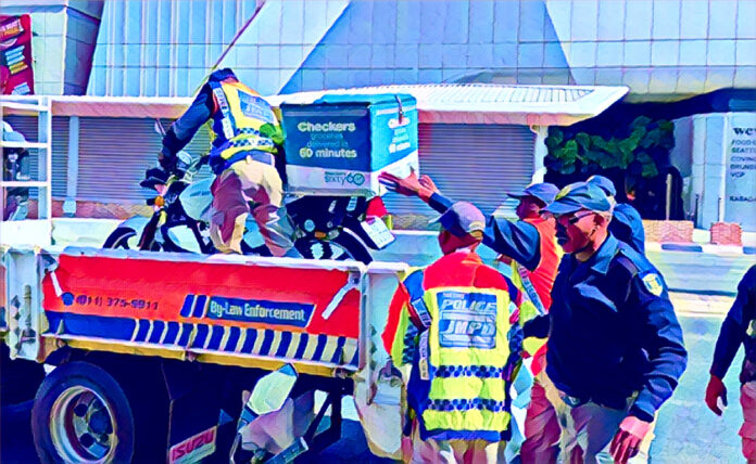 JMPD officers inspect delivery bikes in Rosebank