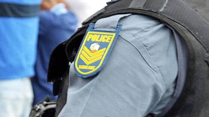 Crime scene tape in front of a South African Police Service vehicle